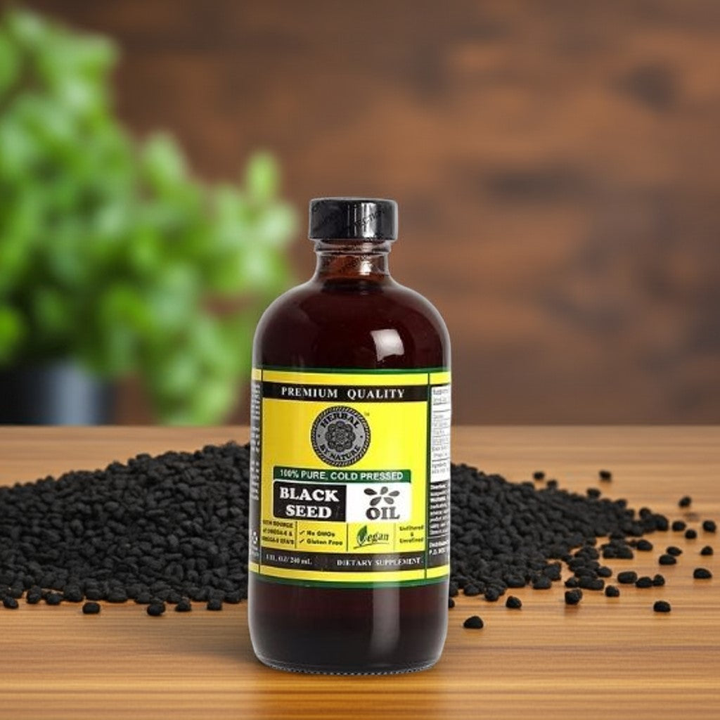 Cold-Pressed Black Seed Oil bottle on wood counter with black cumin seeds