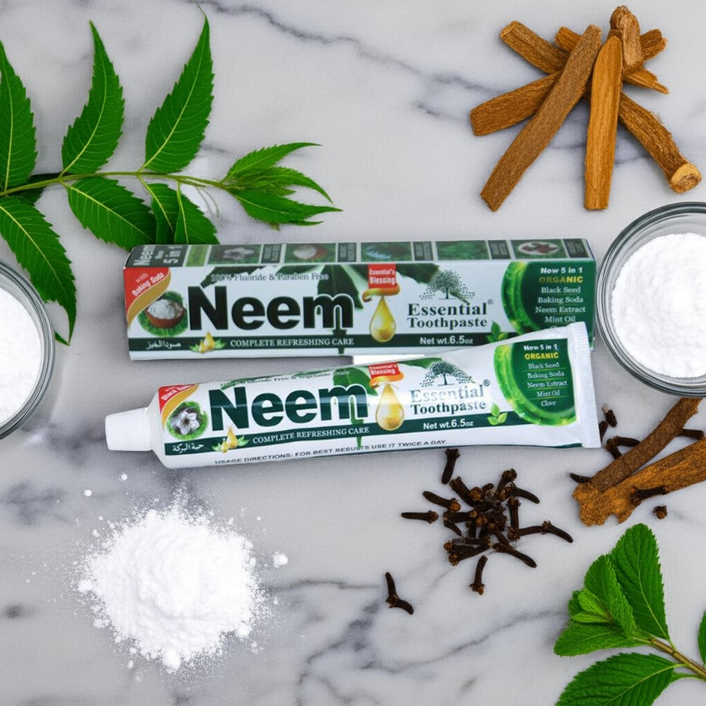 Neem toothpaste with cinnamon sticks, salt, and neem leaves on a marble background