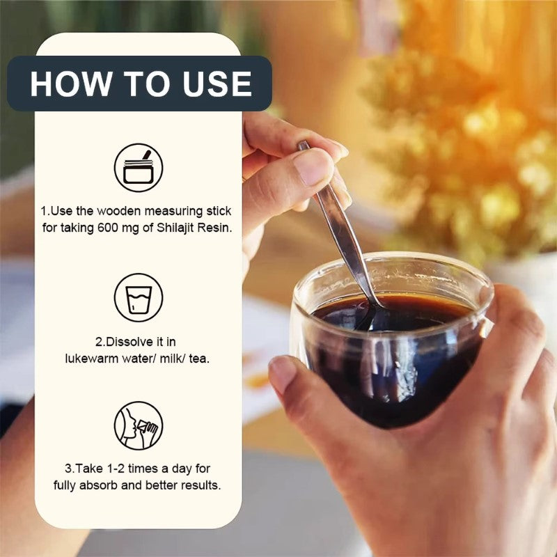Hand holding a wooden measuring stick over a glass of dark liquid with instructions on how to use Shilajit Resin.