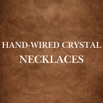 Crafting Hand-Wired Crystal Necklaces with intricate wire-wrapped designs for men and women, showcasing timeless artistry.
