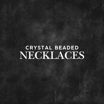 Hand holding multiple Crystal Beaded Necklaces outdoors, showcasing colorful handcrafted healing beads.