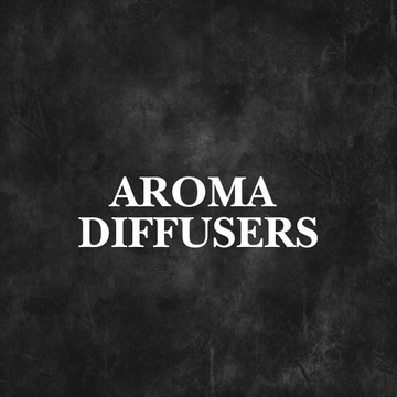 Aroma Diffusers Collection on a table in a cozy bedroom, enhancing wellness with natural scents and essential oils.