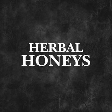 Herbal honey infused with soursop, sea moss, turmeric, and ashwagandha displayed in glass jars.