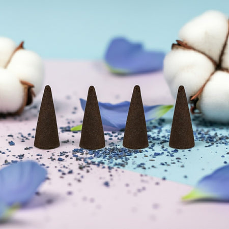 Baby Powder Incense Cones on a decorative surface with cotton and flowers in the background.
