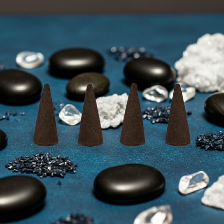 Black Ice Incense Cones and stones on a blue surface