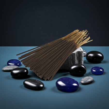 Black Ice Incense Sticks with stones on a blue surface