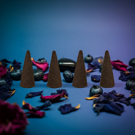 Blueberry Incense Cones on a blue surface with dried flowers and leaves.