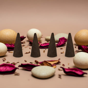 China Musk Incense Cones with stones and petals on a beige background