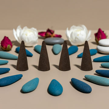 China Rain Incense Cones on a beige surface with flowers and stones in the background