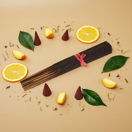 Citronella Incense Sticks with cones, leaves, and orange slices on a beige background