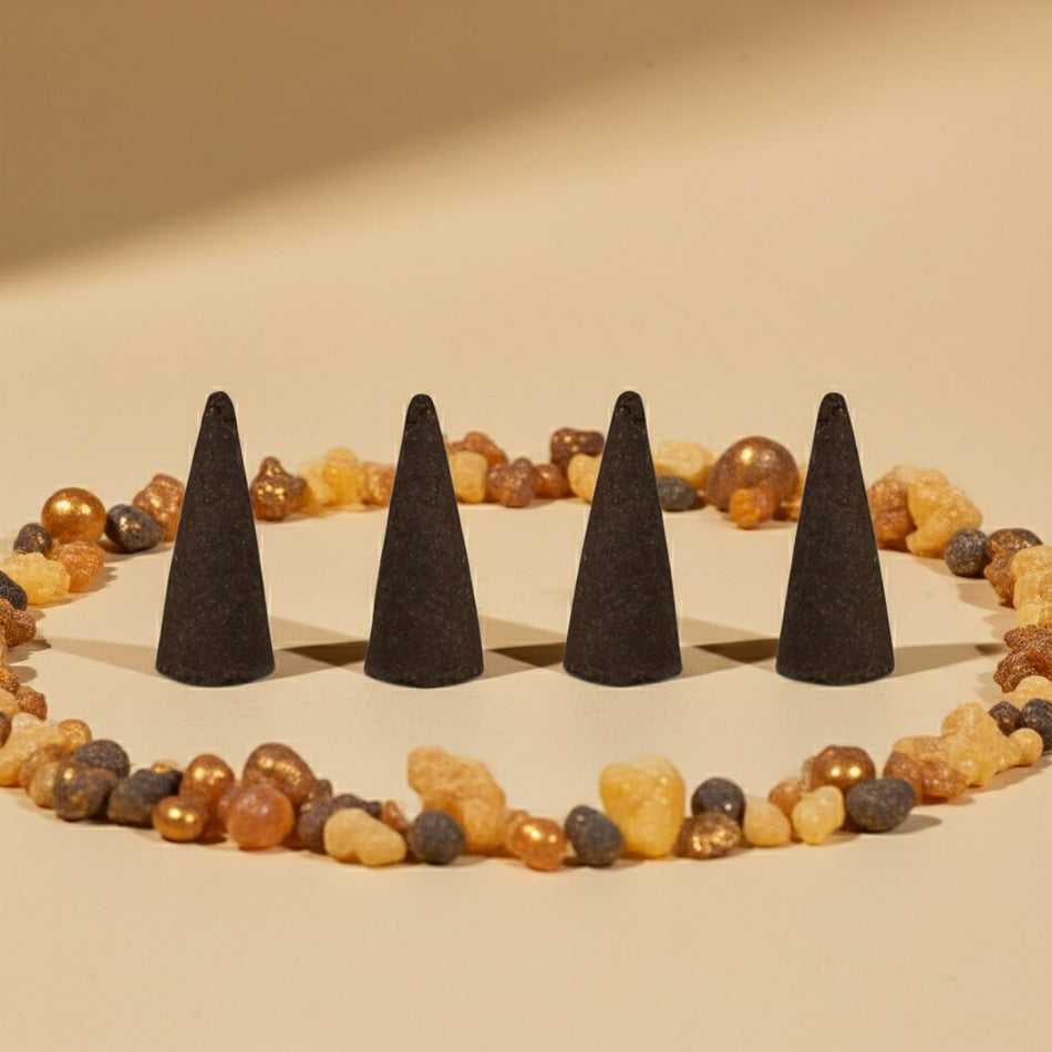 Frankincense Incense Cones on a sandy surface with colorful stones.