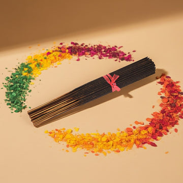 Fruity Pebbles Incense Sticks with colorful floral petals on a beige background