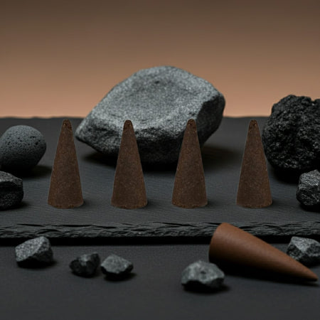 Gucci Guilty Inspired Incense Cones on a dark surface with rocks
