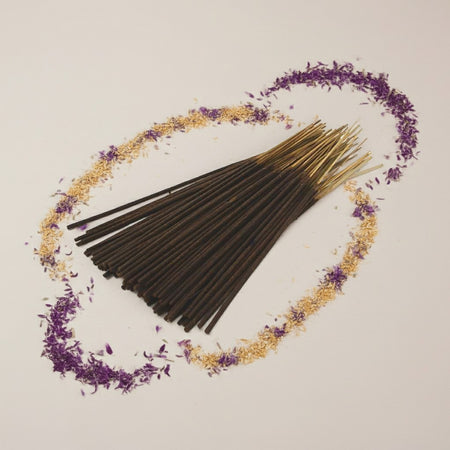 Imported Alien Inspired Incense Sticks arranged in a circular pattern with decorative elements on a light background