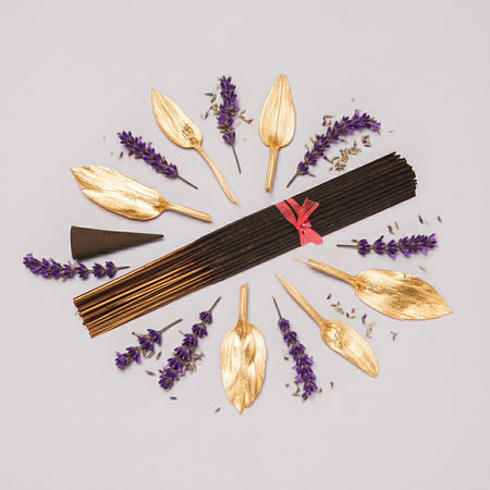 Imported Alien Inspired Incense Sticks with gold cones and lavender flowers on a light gray background