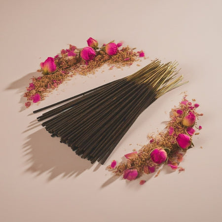 Imported Rose Vanilla Incense Sticks with pink flowers and dried herbs on a beige background