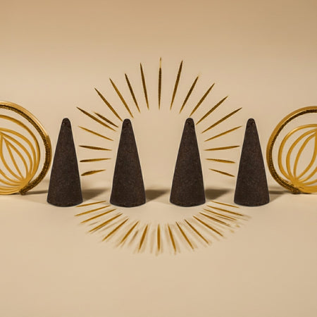 Imported White Oud Incense Cones with gold circular designs on a beige background