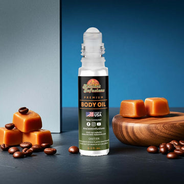 Mugler A Man Inspired Body Oil roll-on with caramel and coffee beans on a blue background. Bold, sweet masculine fragrance bottle.