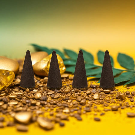 Pineapple Incense Cones on a yellow surface with gold coins and green leaves.