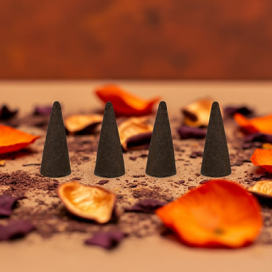 Pumpkin Spice Incense Cones on a sandy surface with orange and purple leaves.
