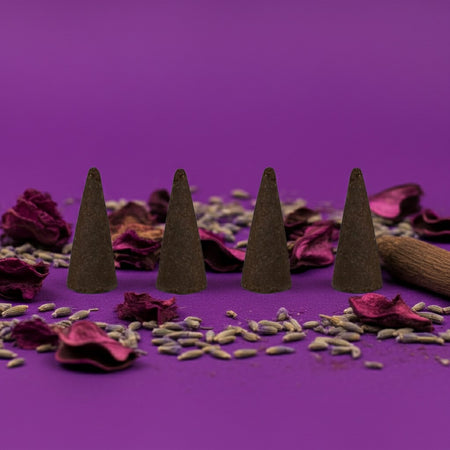 Purple Haze Incense Cones on a purple background with dried flowers and herbs.
