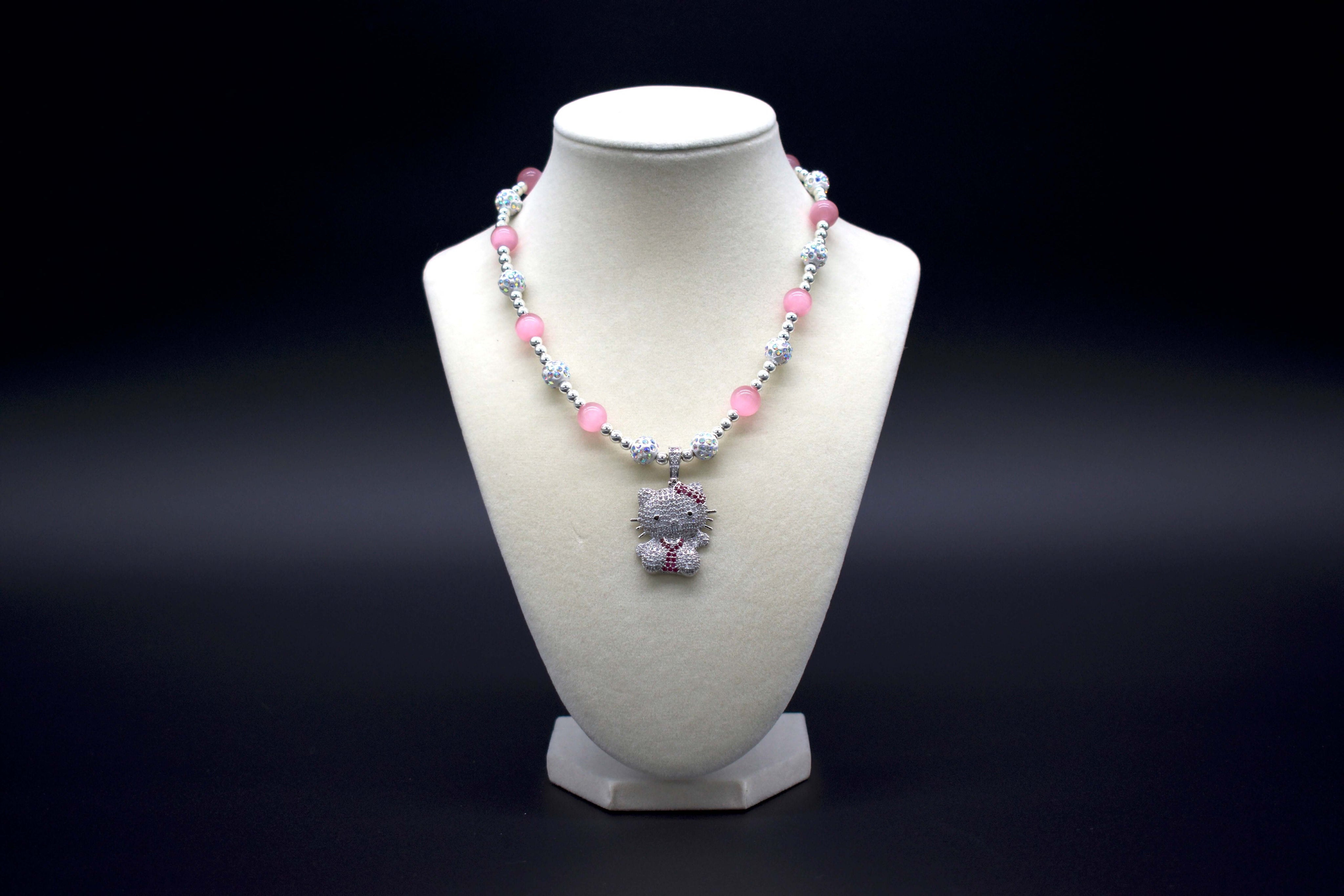 Ancient Infusions Custom Beaded Pink Cat’s Eye Necklace with Hello Kitty pendant, handcrafted with genuine crystals to enhance love, protection, and intuition. Available in multiple lengths.