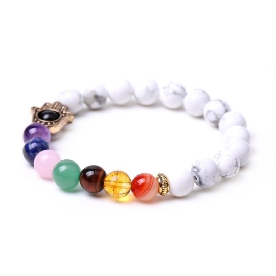 Elevate Your Spirit with Ancient Infusions: Discover the serene balance of the 7 Chakra Howlite Hamsa Elastic Crystal Bracelet. Harness the calming energy of Howlite, align your chakras, and embrace the protective aura of the Hamsa hand. Your journey to spiritual harmony begins here.