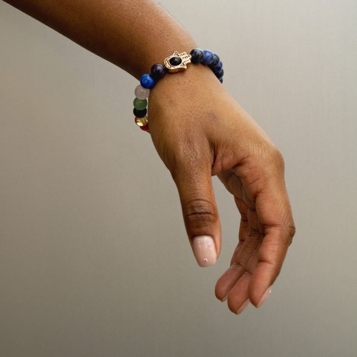 Illuminate your journey with Ancient Infusions' 7 Chakra Lapis Lazuli Hamsa Bracelet, a beacon of wisdom and protection.