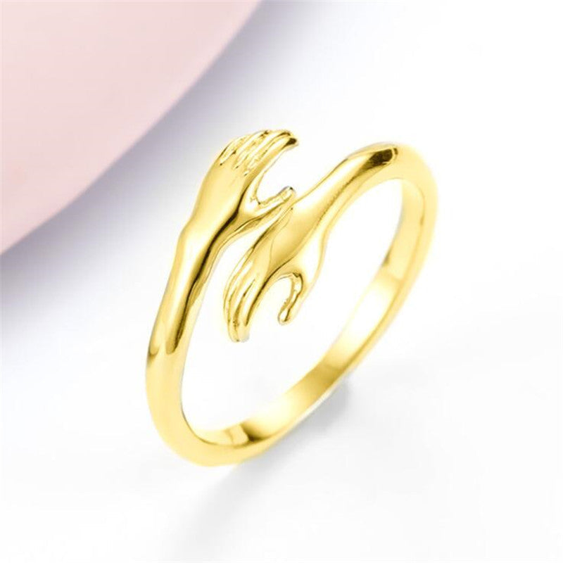 Ancient Infusions - Symbolize unity with our Hugging Hands Alloy Ring in radiant gold.