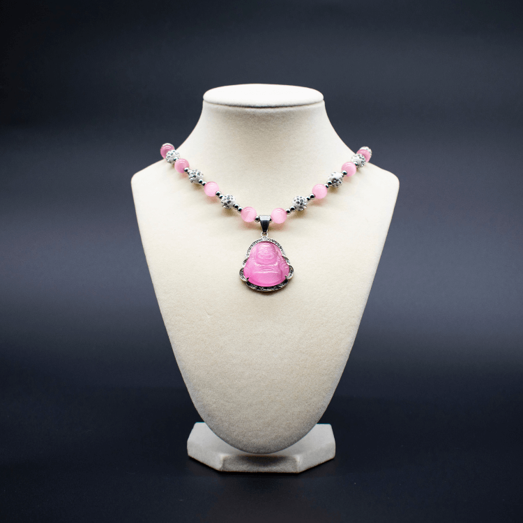 Ancient Infusions Custom Beaded Pink Cat’s Eye Necklace with Laughing Buddha pendant, handcrafted with genuine crystals to promote joy, abundance, and positive energy.