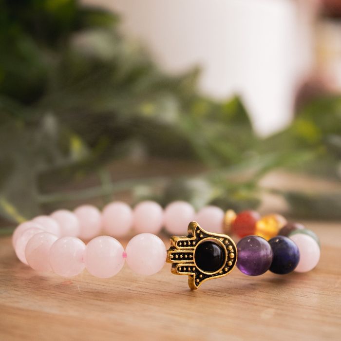 Immerse in love with our 7 Chakra Rose Quartz Hamsa Bracelet by Ancient Infusions.