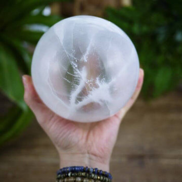 Embrace spiritual clarity with Ancient Infusions' 120mm Selenite Orb, a powerful crystal for cleansing and healing.