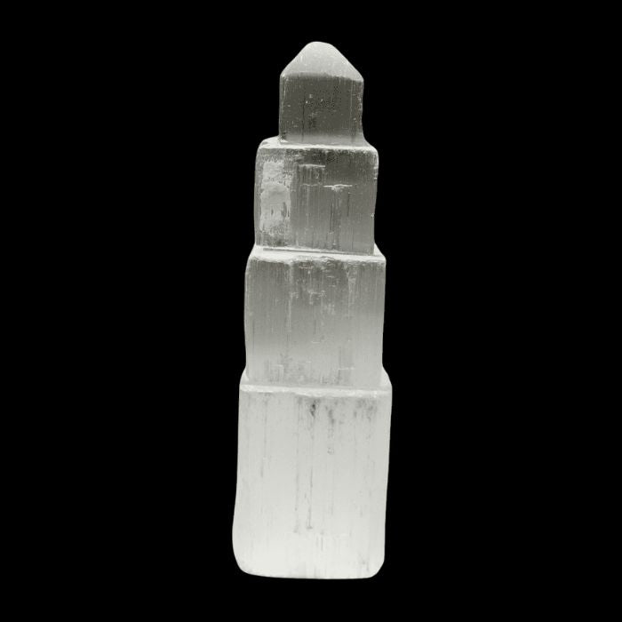 Side view of the hand-carved Selenite Crystal Geometric Tower by Ancient Infusions, promoting mental clarity.
