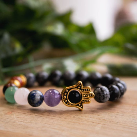 Dive into serenity with our 7 Chakra Snowflake Obsidian Hamsa Bracelet by Ancient Infusions. Experience grounding energy and style in one elegant piece.
