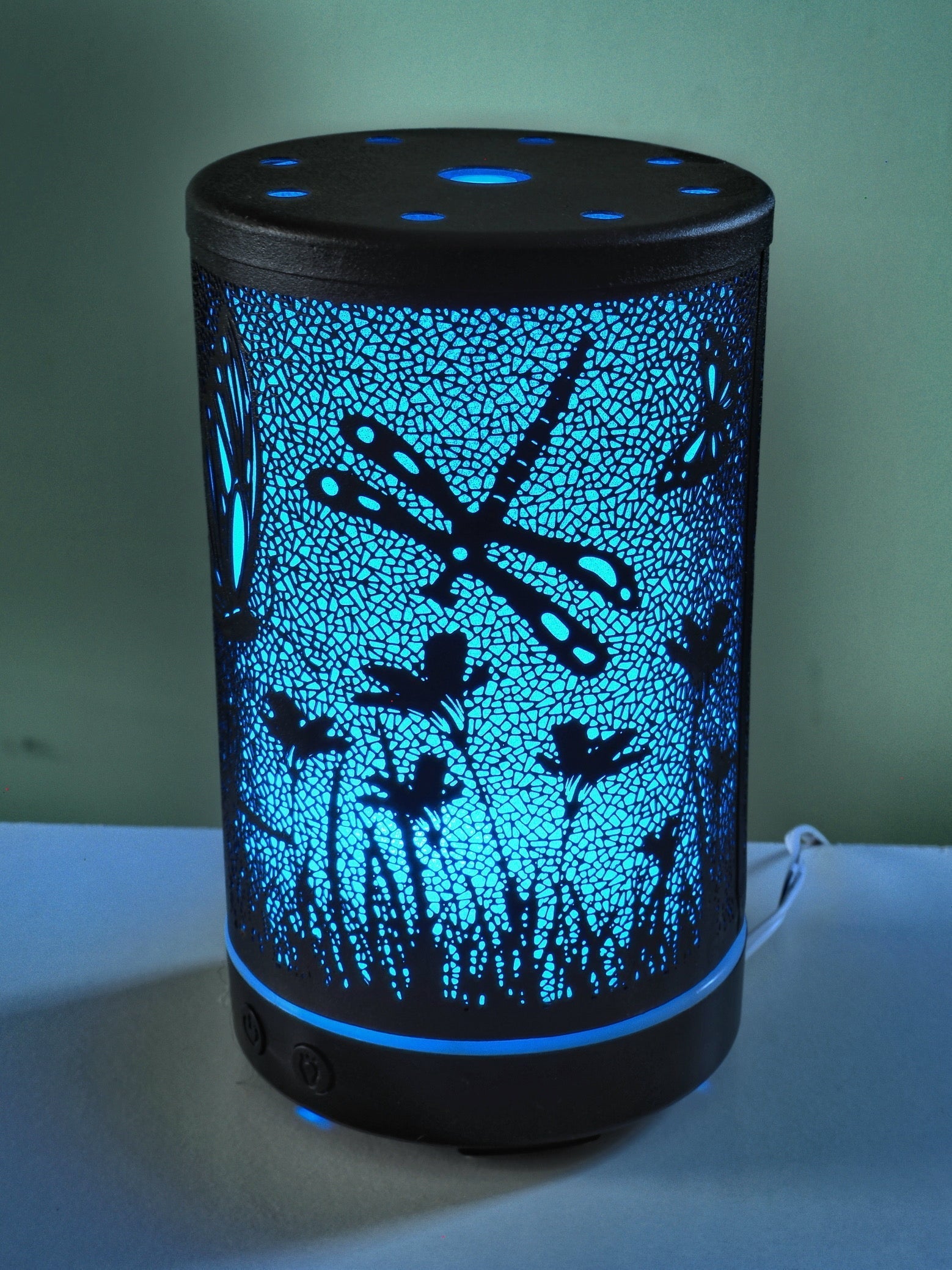 Aromatherapy device spreading calm with butterflies and dragonflies.