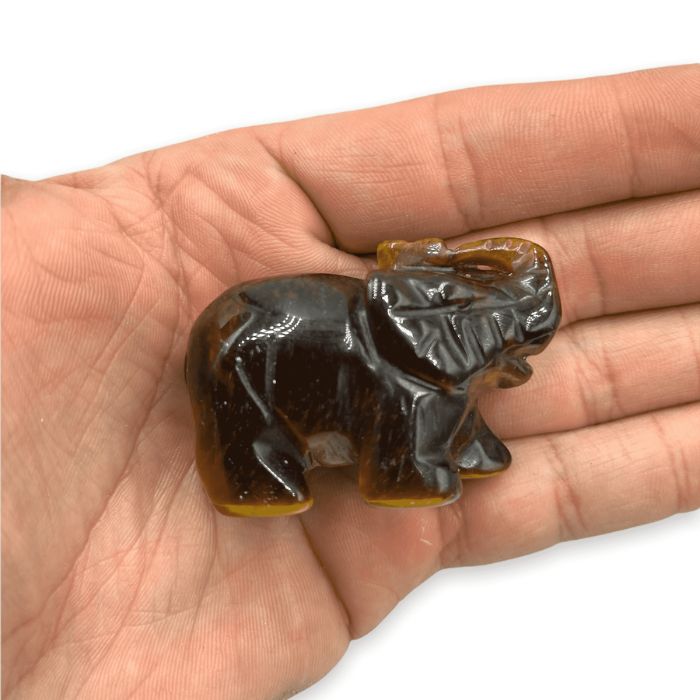 Ancient Infusions Tiger's Eye Crystal Carved Elephant - A symbol of courage and strength in the mesmerizing tones of tiger's eye.