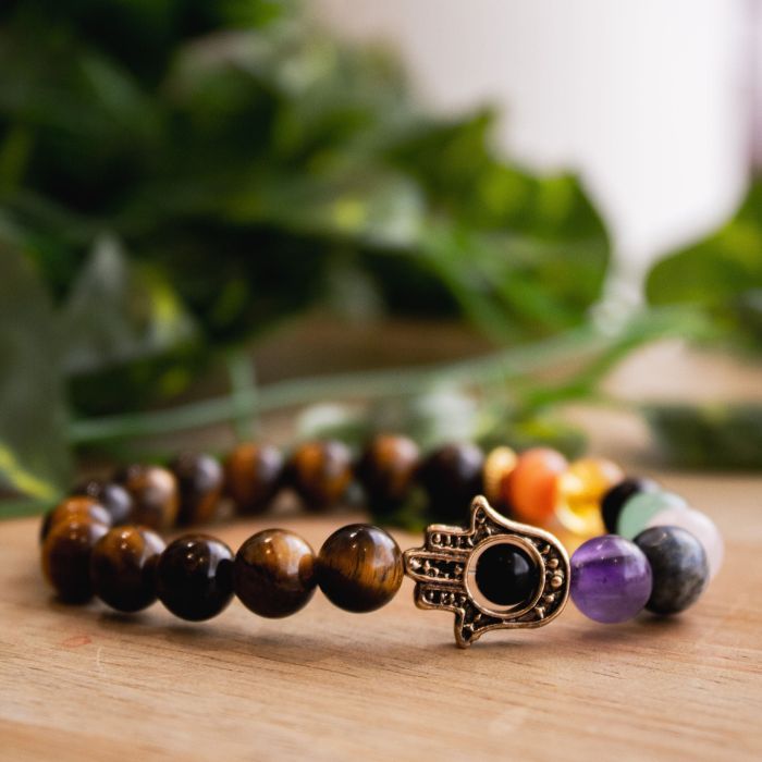 Explore the exquisite side profile of our 7 Chakra Tiger's Eye Hamsa Elastic Crystal Bracelet, blending style with spiritual significance.