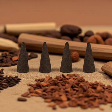 Arabian Sandalwood Incense Cones on a sandy surface with various natural items in the background.