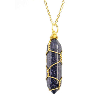 Close-up of a Blue Goldstone Necklace featuring a sparkling gemstone wrapped in handcrafted gold wire with a stainless steel chain.