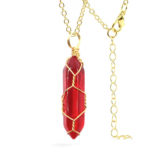 Close-up of a Carnelian Necklace featuring a vibrant gemstone wrapped in handcrafted gold wire with a stainless steel chain.