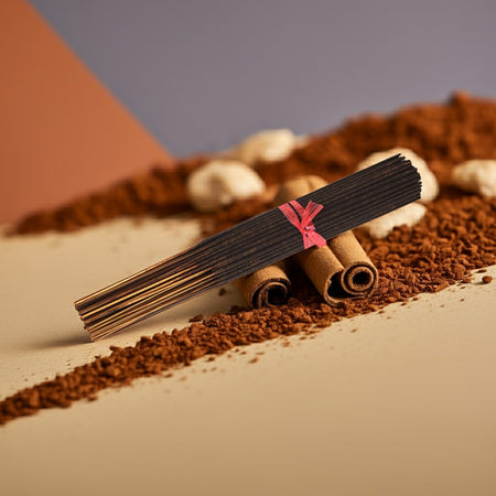 Cinnamon Incense Sticks  with a red band on a dessert with cinnamon crumb topping