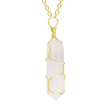 Close-up of a Crystal Quartz Necklace featuring a clear gemstone wrapped in handcrafted gold wire with a stainless steel chain.