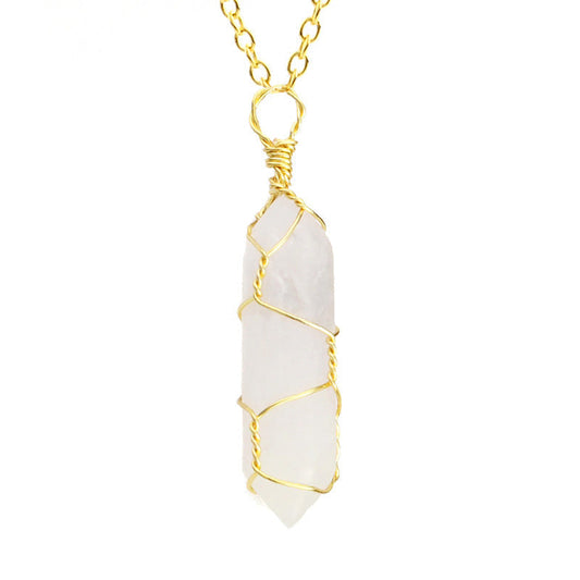 Close-up of a Crystal Quartz Necklace featuring a clear gemstone wrapped in handcrafted gold wire with a stainless steel chain.