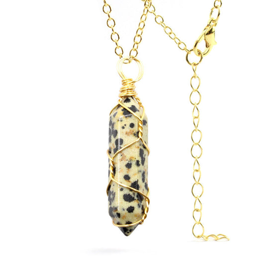 Close-up of a Dalmatian Jasper Necklace featuring a speckled gemstone wrapped in handcrafted gold wire with a stainless steel chain.