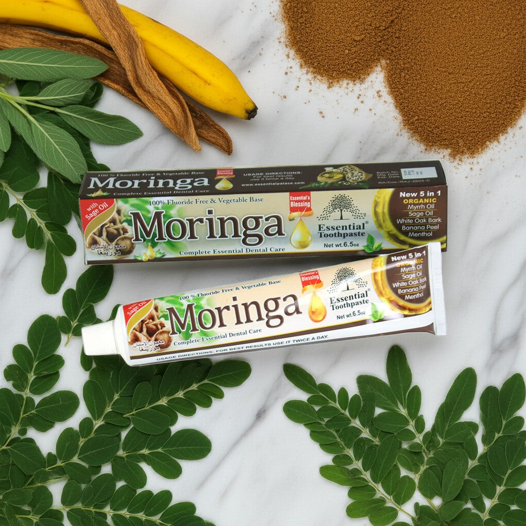 Essential Palace Moringa 5-in-1 Fluoride-Free Toothpaste with moringa leaves, sage, myrrh, and banana peel on marble counter
