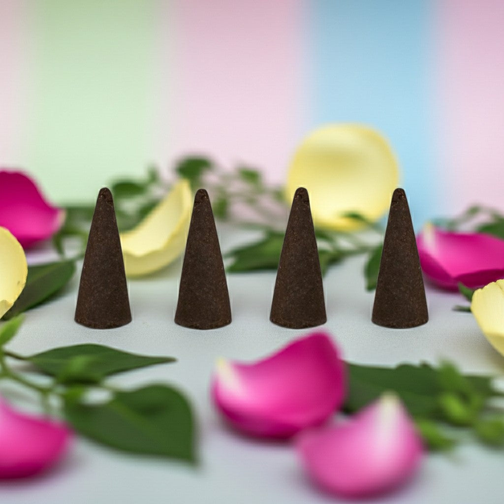 Flower Shop Incense Cones on a surface with pink and yellow flowers and green leaves.