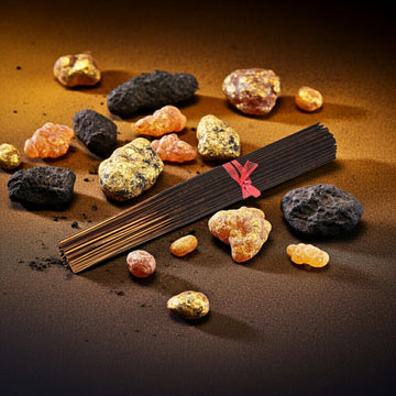 Frankincense & Myrrh Incense Sticks with a red label surrounded by various colored stones on a brown background