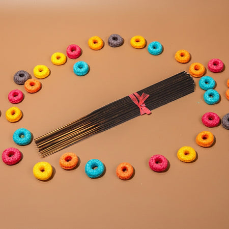Fruit Loops Incense Sticks with colorful donut-shaped candies on a brown background