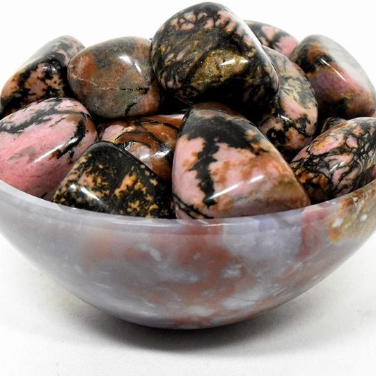 Bulk Rhodonite stones for sale, emphasizing their meaning, spiritual benefits, and calming energy.