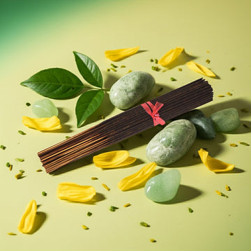 Green Apple Incense Sticks with a pink label on a green background with stones and leaves